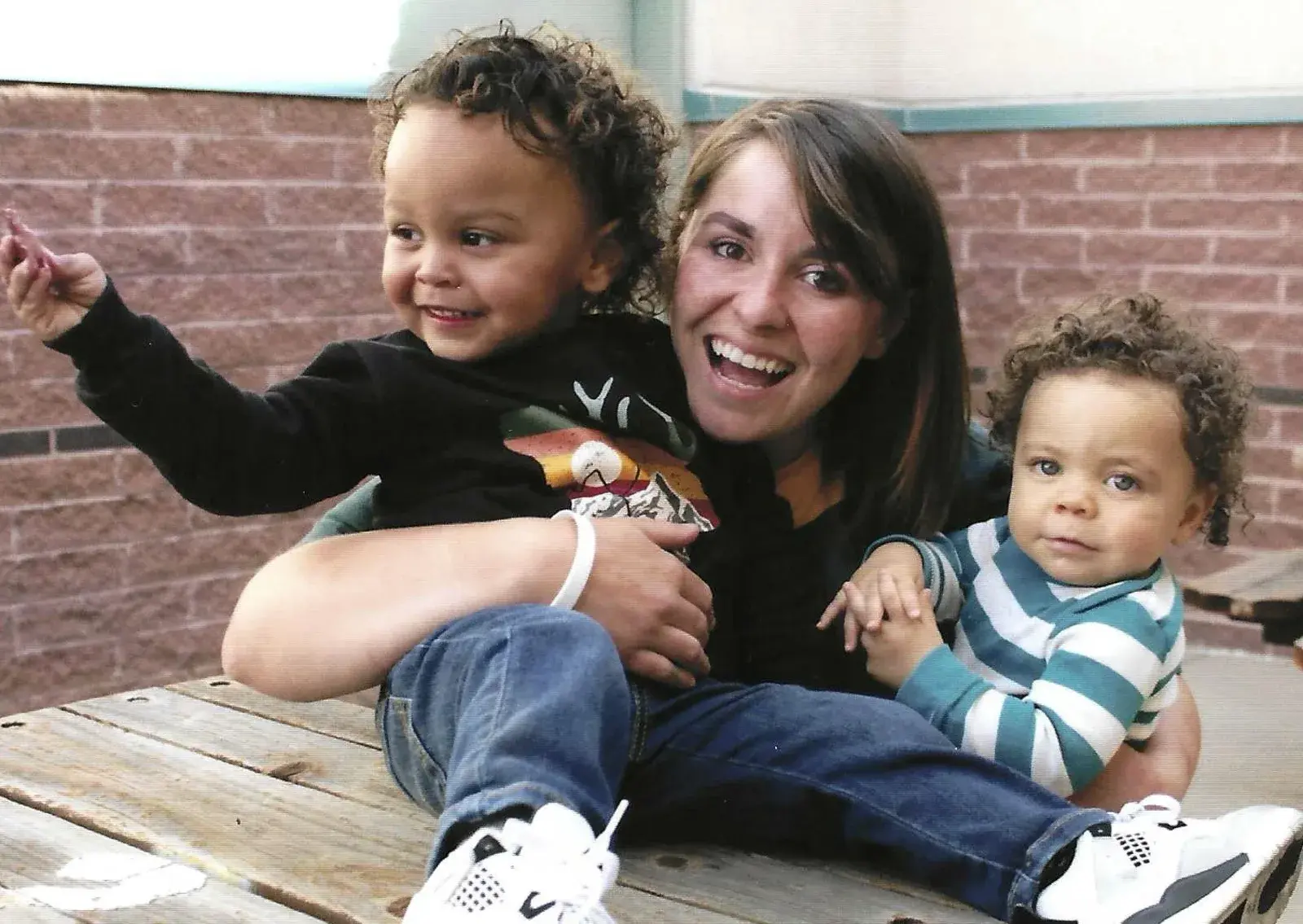 A Forever Moms mother smiling with her two young children