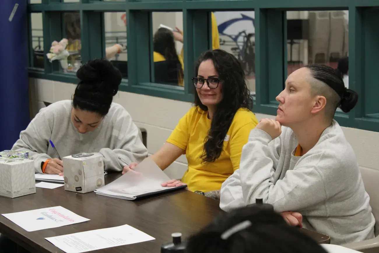 A Forever Moms facilitator working alongside mothers during a program session